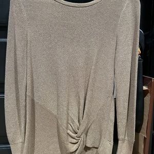 Woman’s gold sweater
